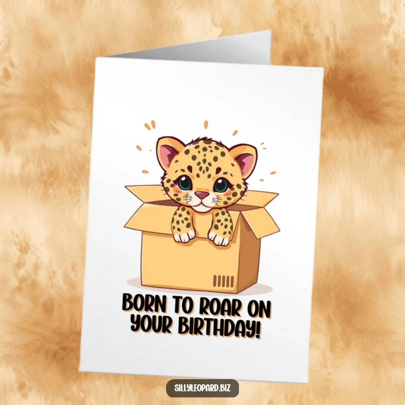 Funny Free Printable Birthday Card: A spotted leopard cub comically bursting out of a large, open cardboard office box with excitement.